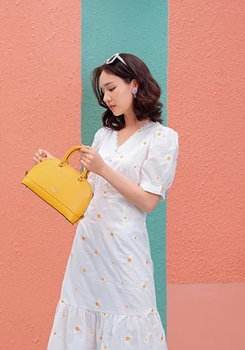woman posing with yellow purse